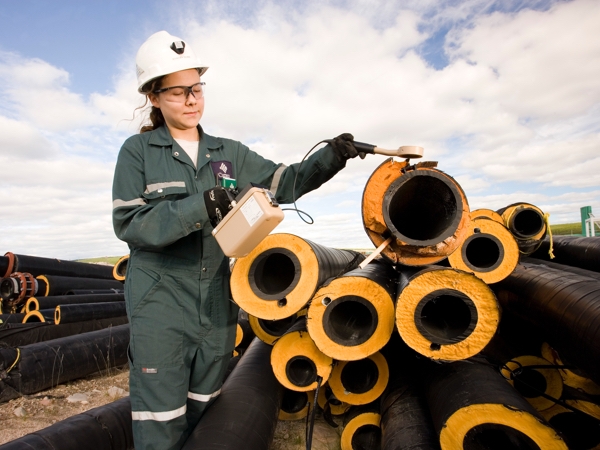 Person beside pipes